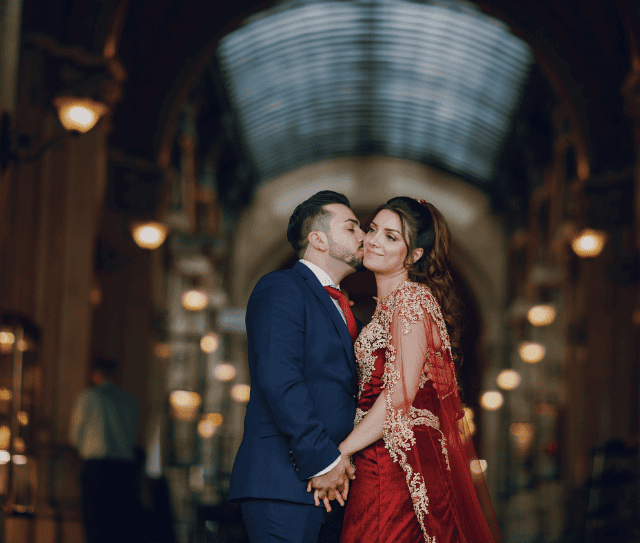 beautiful-woman-long-red-dress-walks-around-city-with-her-husband (1)